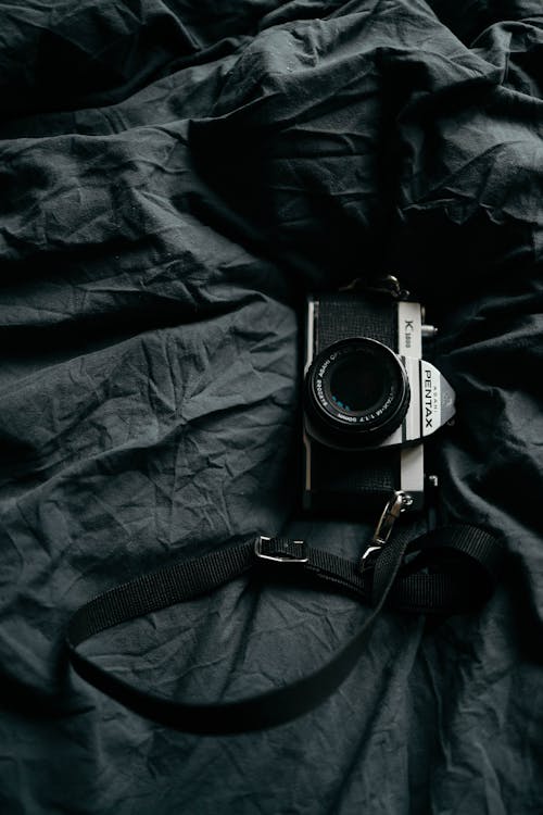 Free Camera Lying on Bed  Stock Photo