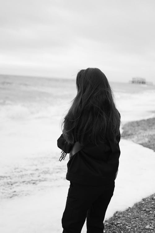 Grayscale Photograph of a Woman at the Beach