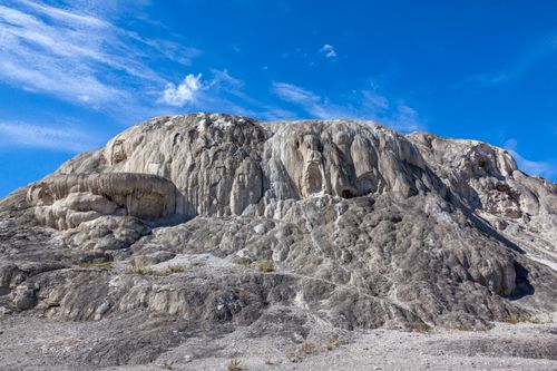 Free Majestic travertine terrace formation at Yellowstone under clear blue skies. Stock Photo