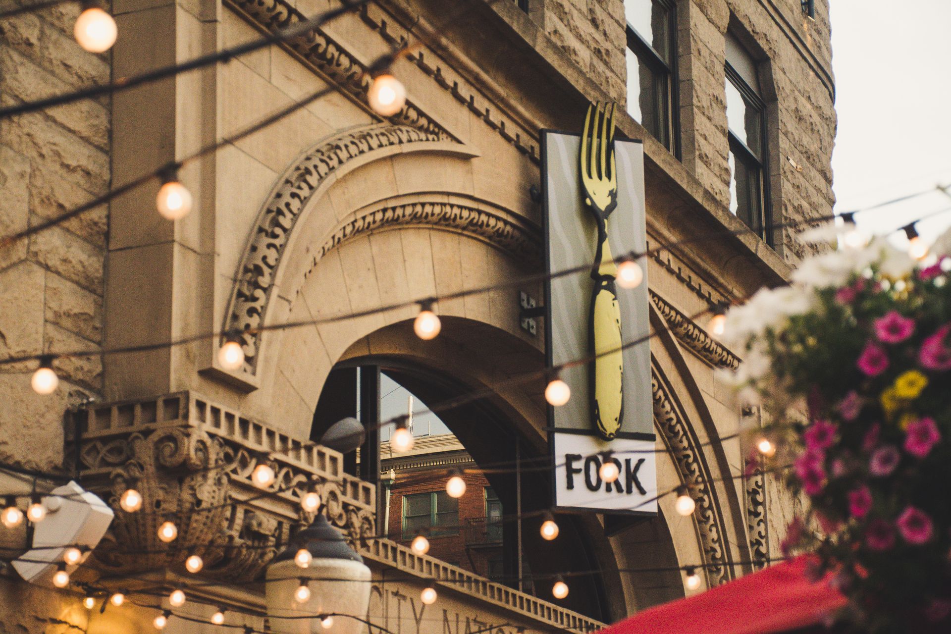 Grey and Black Fork Signage Hanging on Brown Concrete Building