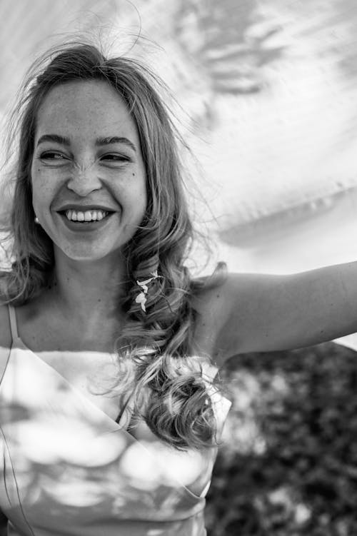 Grayscale Photo of a Woman Laughing