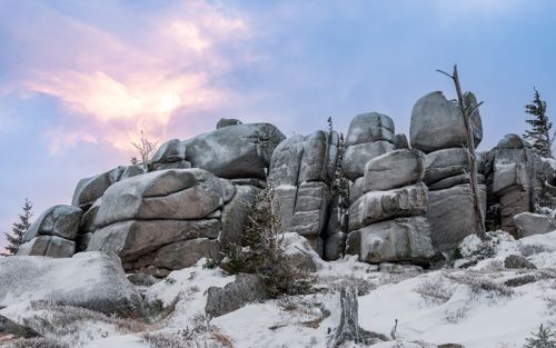 Free A stunning winter rock formation under a colorful sunset sky, showcasing nature's beauty. Stock Photo