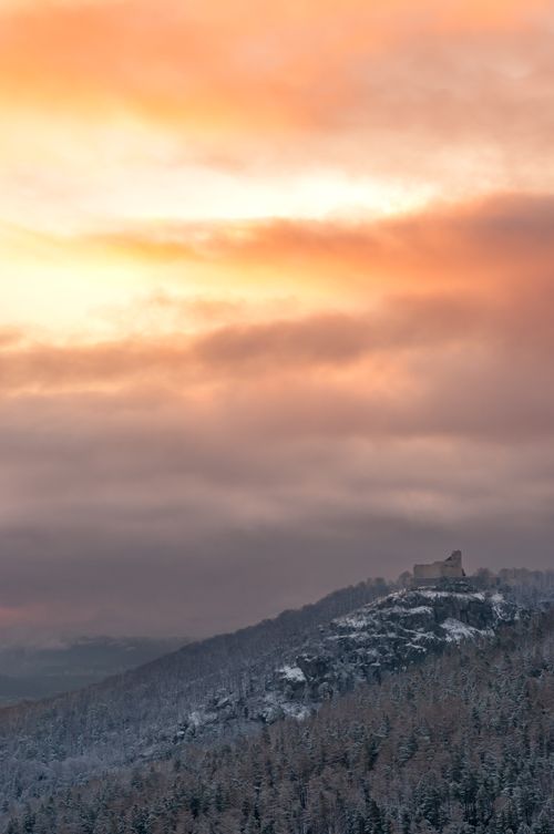 Free Stunning winter sunset over a scenic snow-covered mountain offering a peaceful and dramatic landscape view. Stock Photo