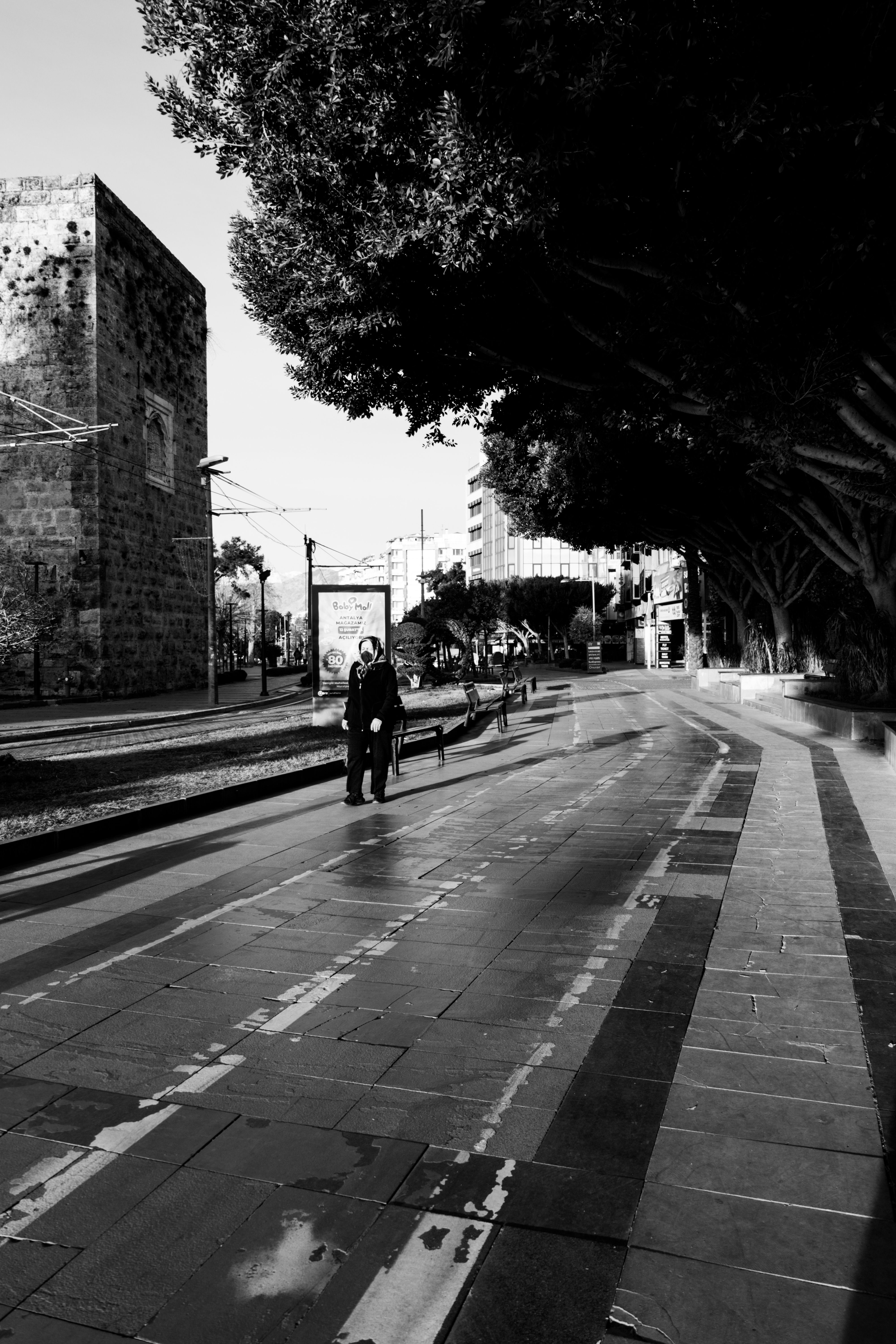 Grayscale Photo of a Person Walking on the Street · Free Stock Photo