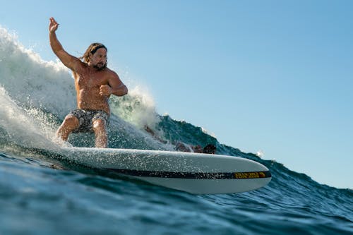 Shirtless Man Surfing