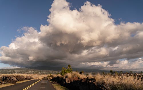 Highway across a Plateau under a Cloudy Sky 