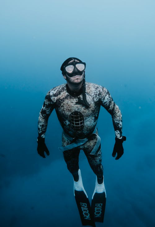 Free Man in Drysuit Underwater Stock Photo