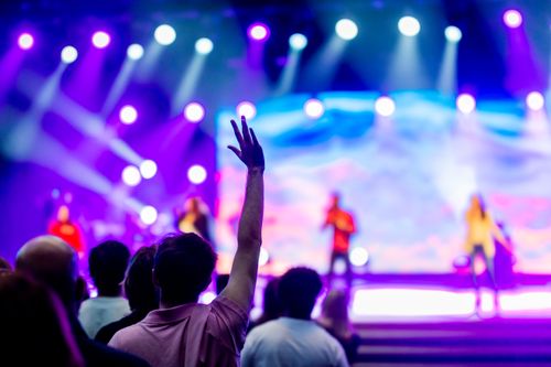 Free Vibrant music concert with colorful lights and excited crowd enjoying the performance. Stock Photo