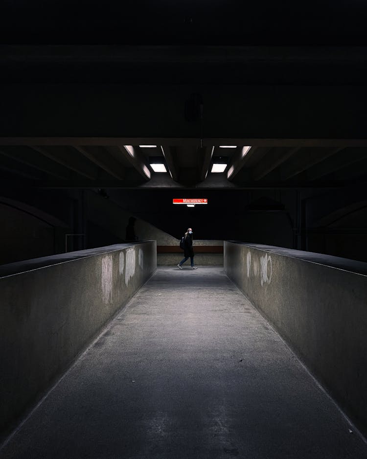 Person Walking In A Dark Aisle