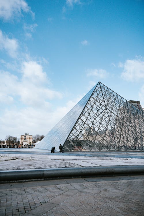 A Louvre Museum Under the White Clouds and Blue Sky