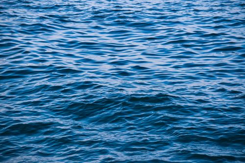 Free A serene view of blue ocean waves and tranquil ripples, perfect for backgrounds. Stock Photo