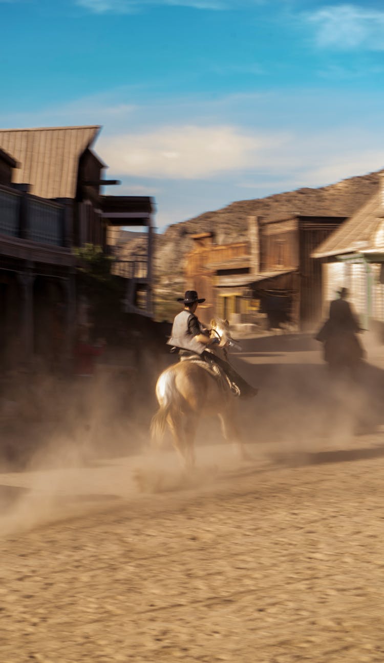 Cowboy Riding Horse In Village 