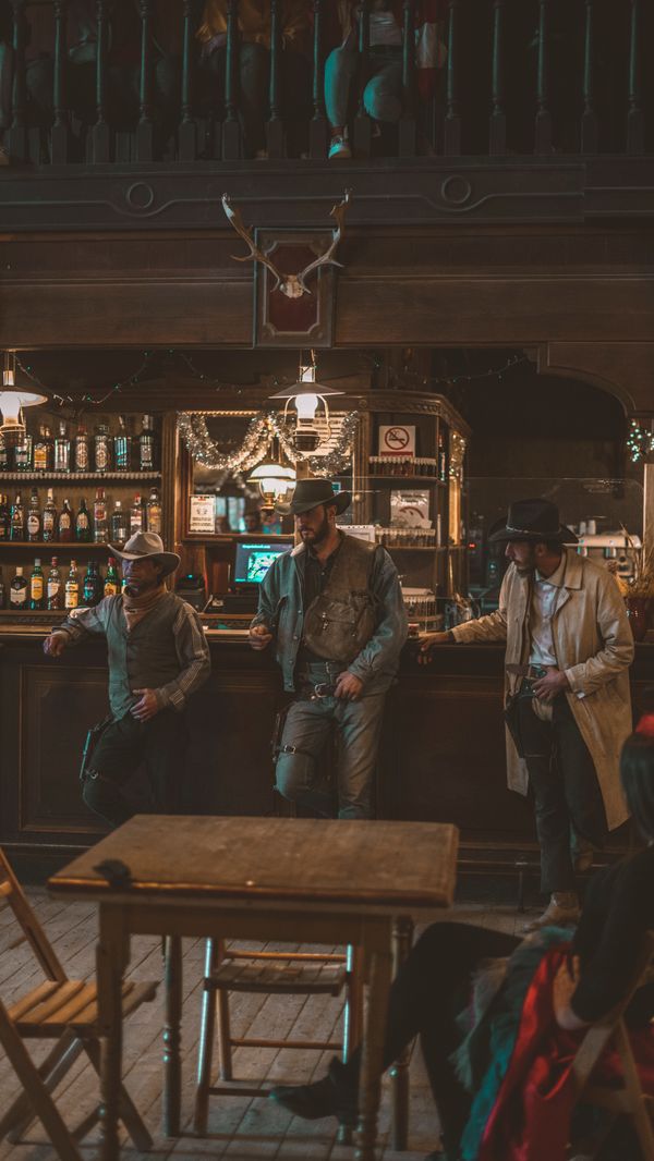 Cowboys at a rustic saloon bar — photo by ricardo cristian on Pexels