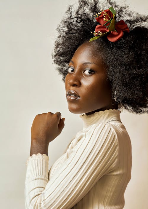 A Woman in White Turtleneck Sweater with Flower on Her Hair