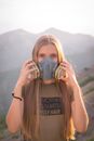 Woman in Gray Crew Neck T-shirt Wearing Black and White Gas Mask