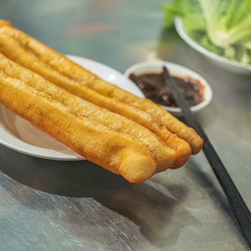 Chinese Tea-Cured Egg with Crispy Youtiao and Chili Oil on Mantou