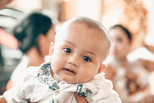 Free Baby in White Top in Tilt Shift Lens Shot Stock Photo