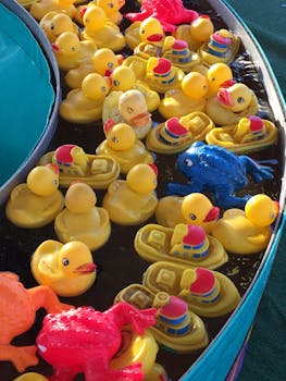 Vibrant rubber ducks floating in a carnival game, full of playful colors.