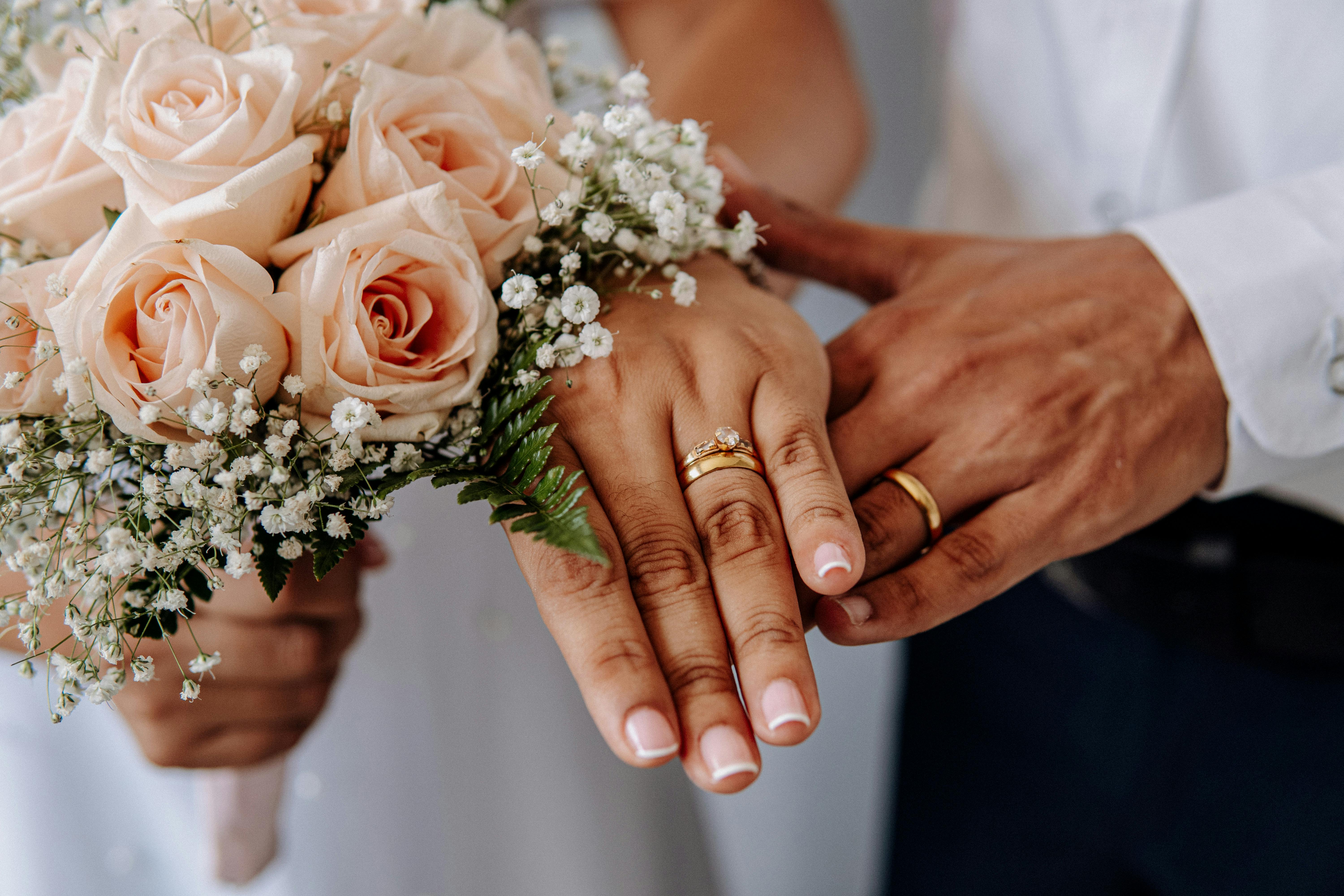 husband and wife hand with rings on wedding day