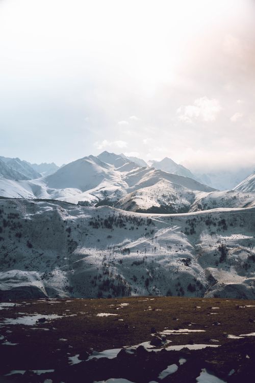 Free Stunning view of a snow-capped mountain range under a bright sky, perfect for nature enthusiasts. Stock Photo