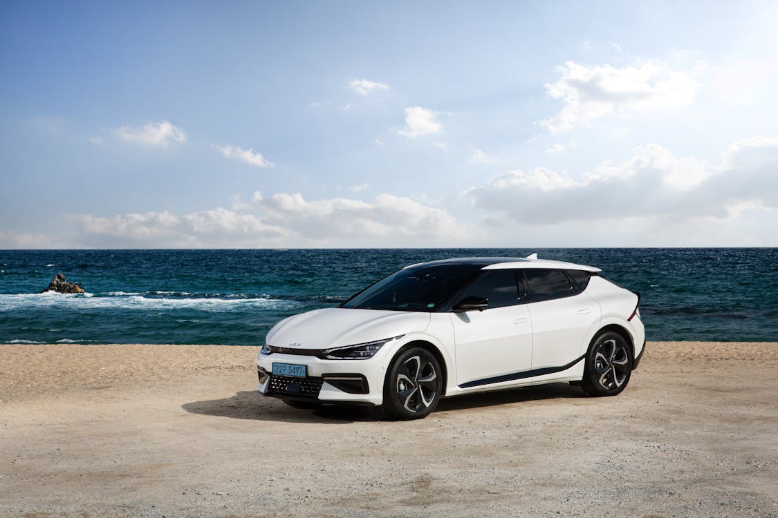 Free White Vehicle Parked on the Beach Stock Photo