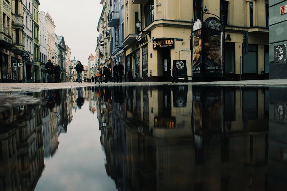 Reflection Of Buildings On Puddle