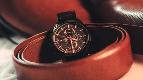 Stylish close-up of brown leather shoes, belt, and wristwatch for fashion-forward men.