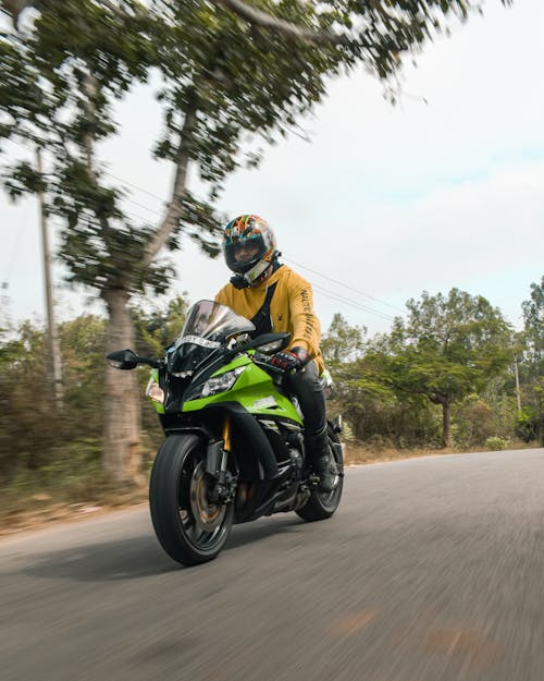 Man Riding a Green Motorcycle