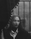 Woman Looking Out The Window in The Rain