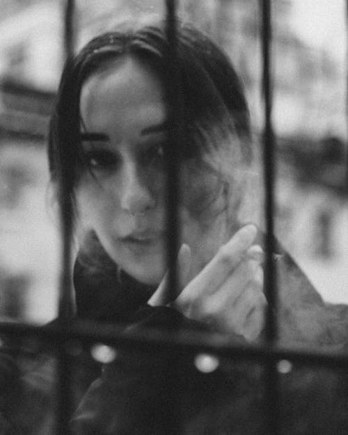 Black and White Photo of a Woman Smoking a Cigarette 