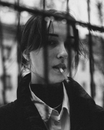 A Woman Smoking a Cigarette and Looking at Camera