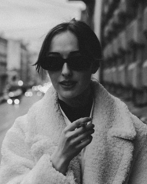 Free Monochrome Shot of a Woman Holding a Cigarette Stock Photo