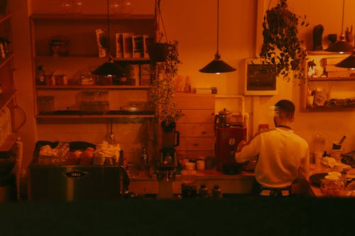 Back View of a Man Working on a Kitchen