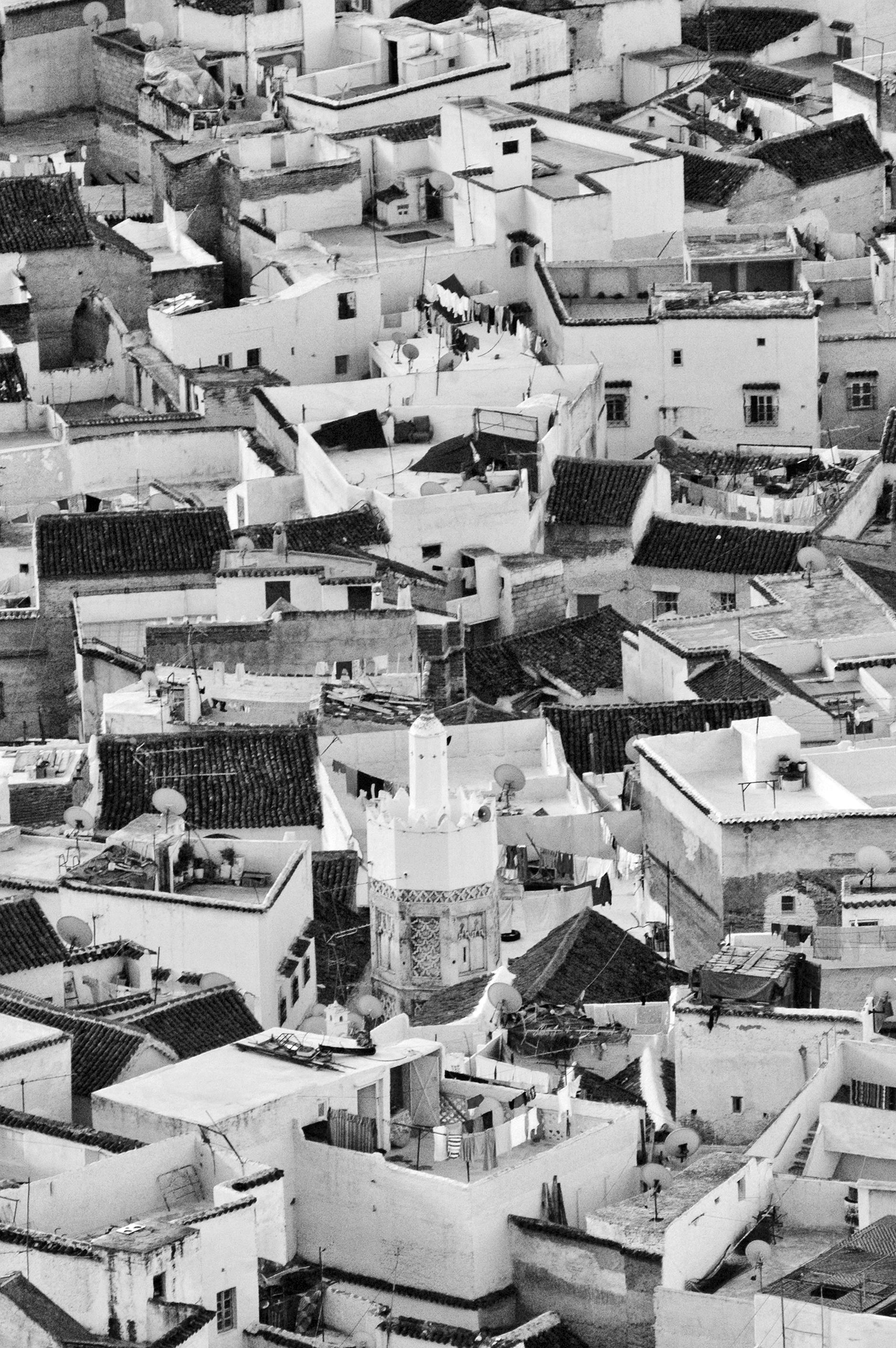 Monochrome aerial view of Chefchaouen's distinctive rooftops in Morocco's mountainous region.