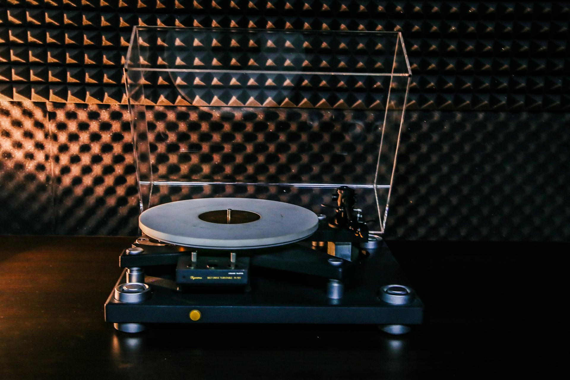 A classic turntable sits in a soundproofed room, ideal for audiophiles.