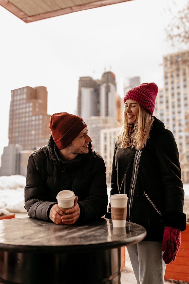 A Couple Having A Coffee Outside In Winter Weather 