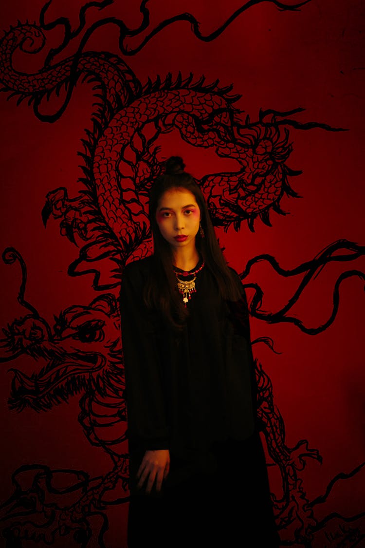 Woman Standing With Dragon Drawing In Background