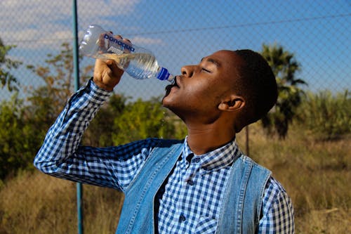 Photography of A Man Drinking Water