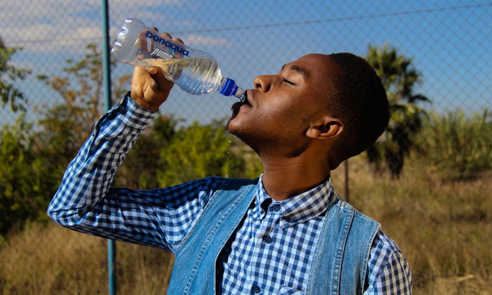traveler drinking bottled water africa