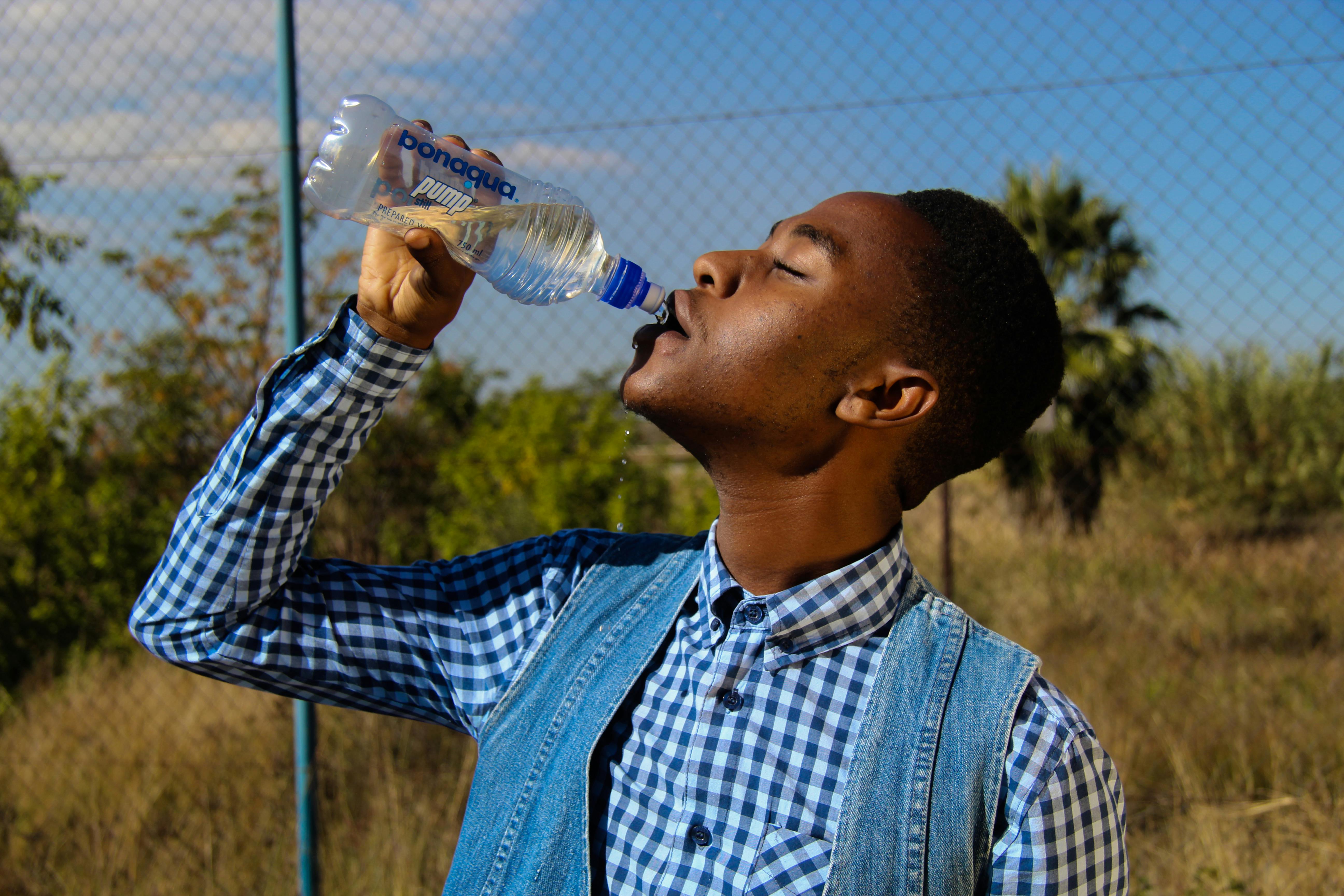 person drinking water bottle
