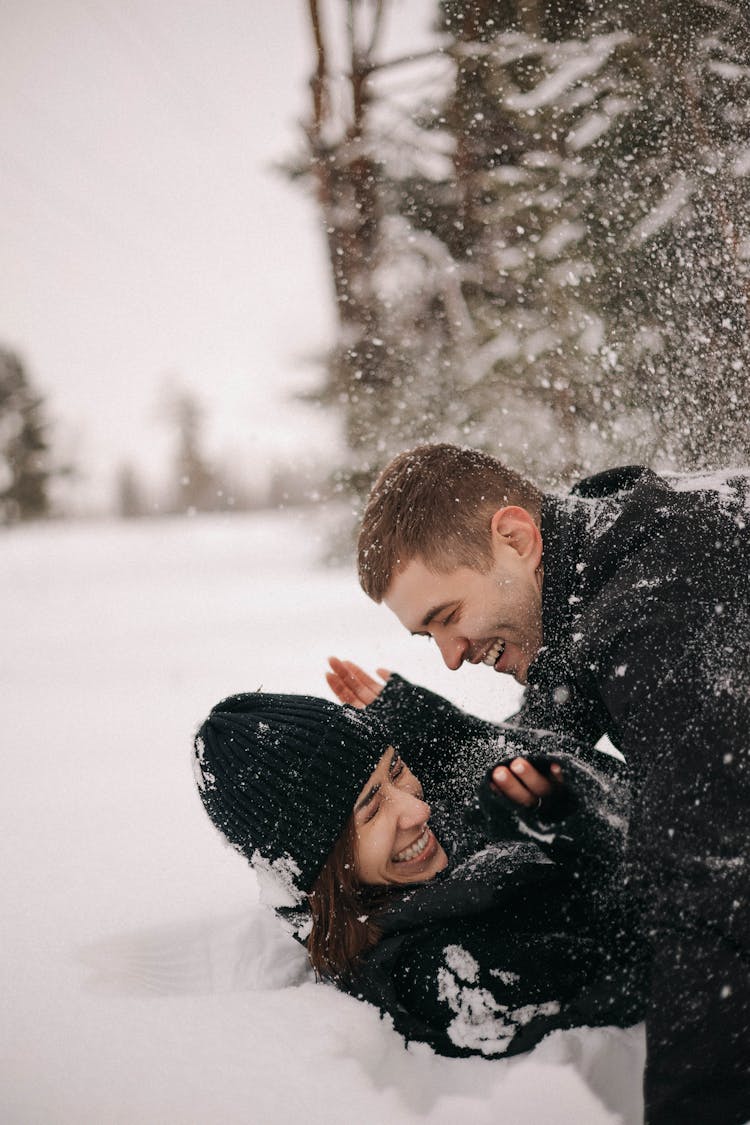 Couple Playing In The Snow 