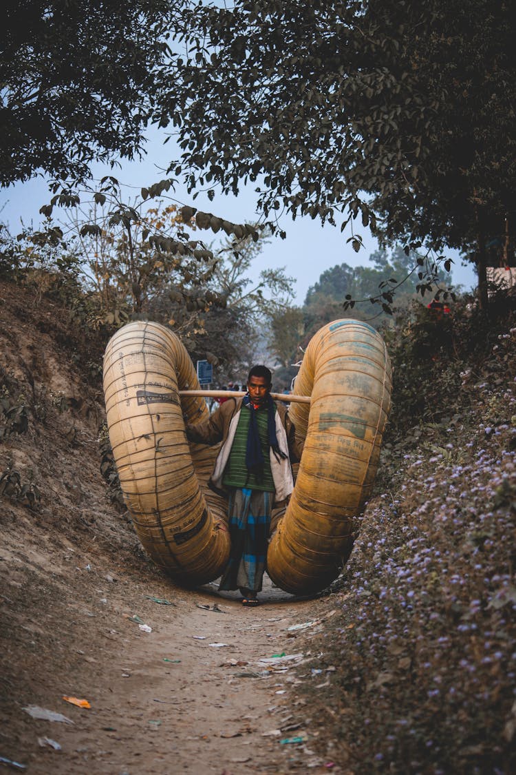 Man Carrying Load In Countryside