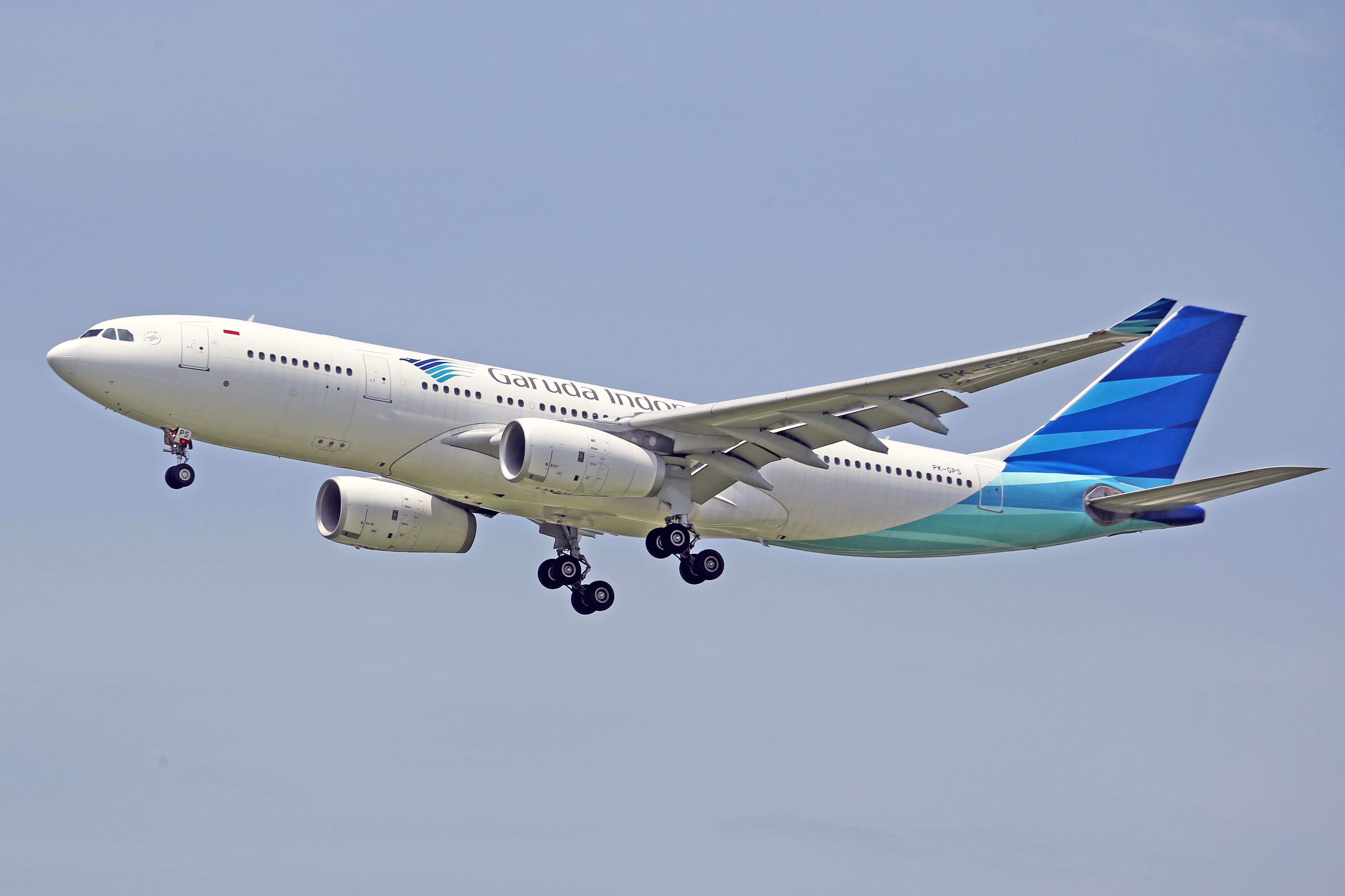 White and Blue Airplane Flying in the Sky