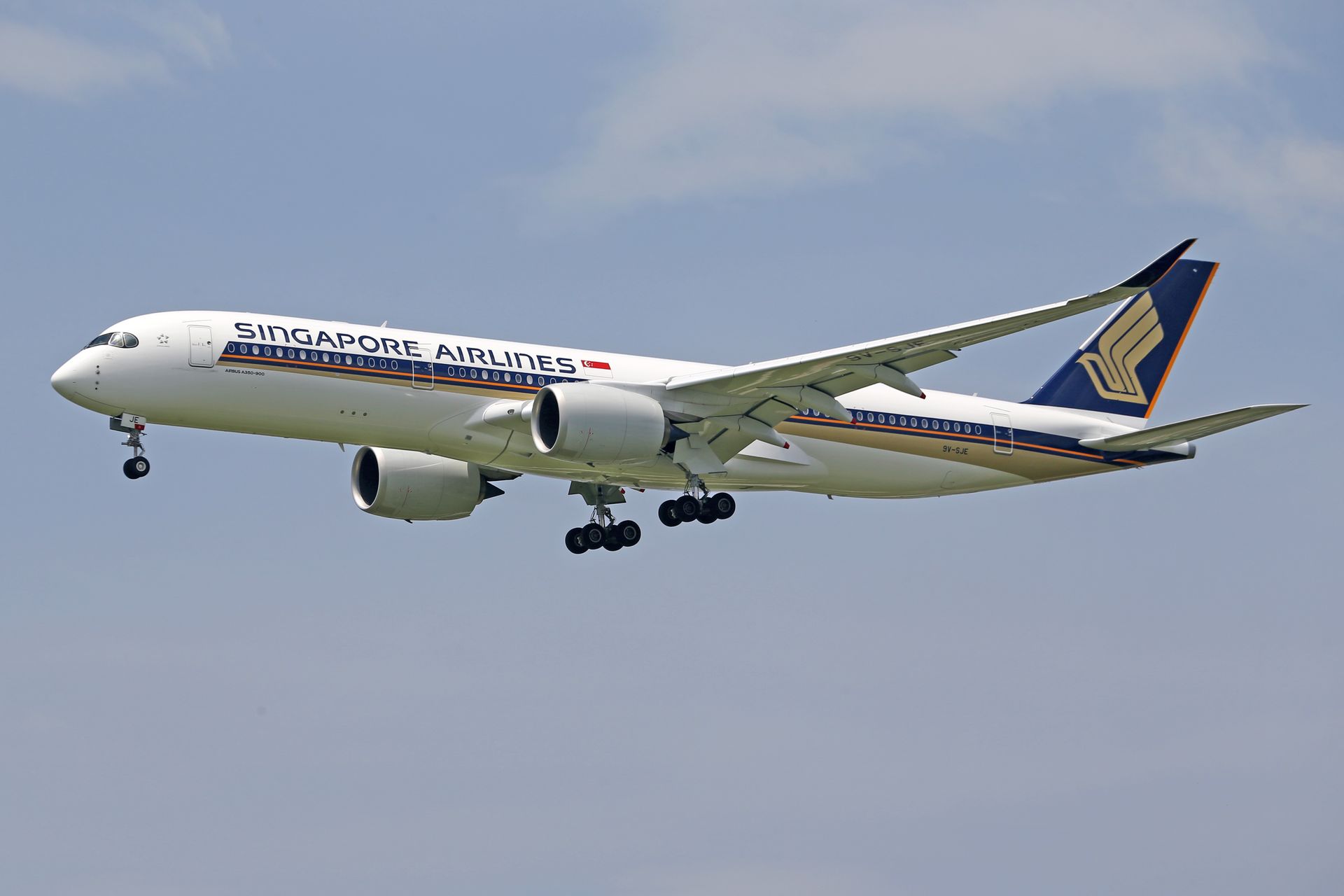 Singapore Airlines plane flying through the sky, showcasing elegant design and modern aviation technology.