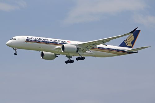 Free Singapore Airlines plane flying through the sky, showcasing elegant design and modern aviation technology. Stock Photo