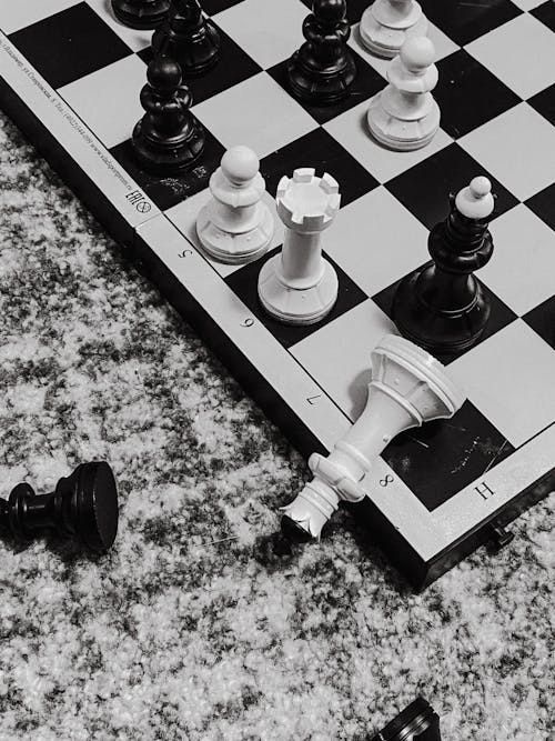 Download Black and White Chess Battle on the Board Wallpaper