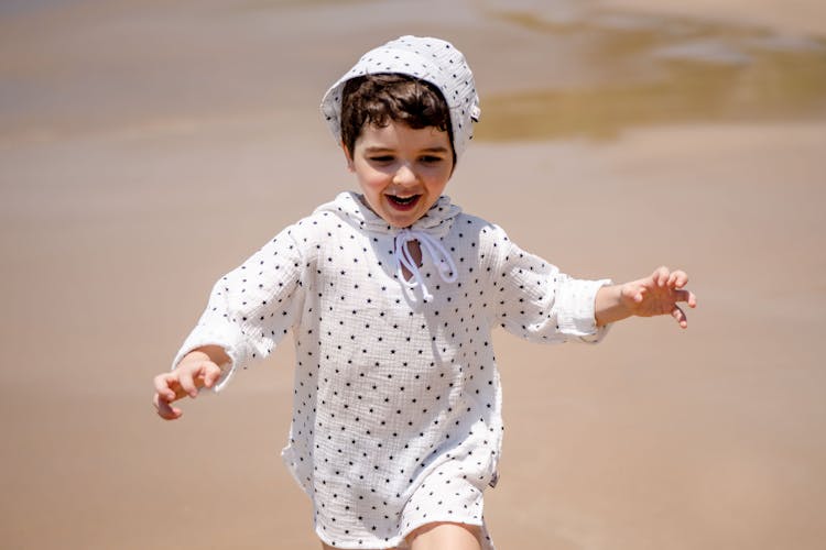 Cute Boy Running On Beach