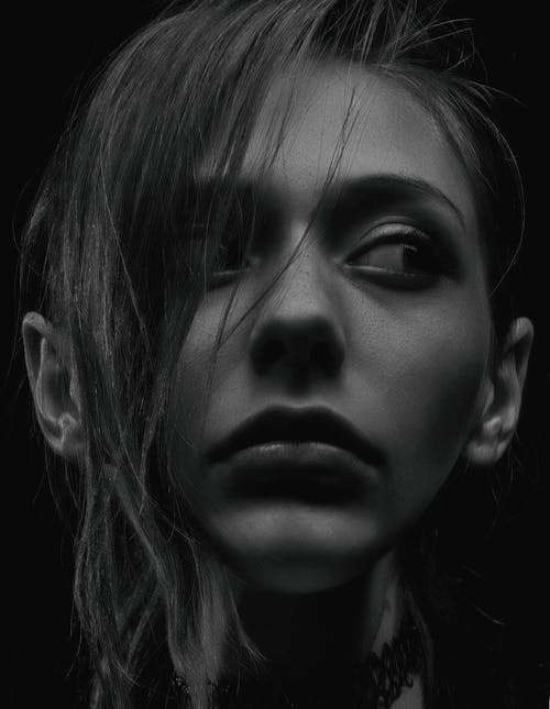 Grayscale Photography of Woman Looking Sideways