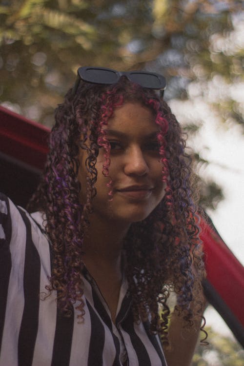 Free Woman in Striped Shirt Wearing Black Sunglasses on Her Head Stock Photo