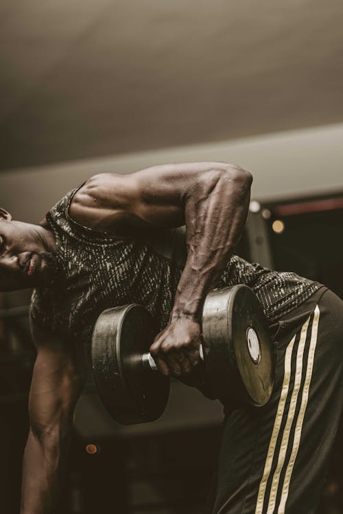 A Man Lifting Dumbbell while Wearing Virtual Goggles · Free Stock